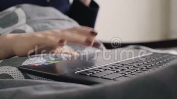 在舒适的床上用手提电脑工作的女性视频的预览图