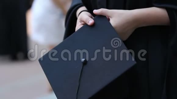 毕业学生的双手拿着学术帽在毕业证书颁发前感到紧张视频的预览图