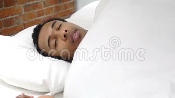 不舒服的非洲男人晚上睡在床上不安视频的预览图