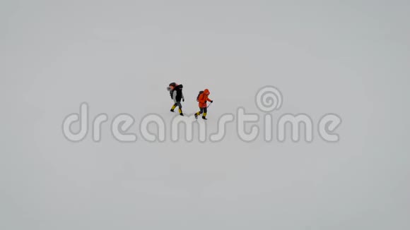 雪中两人漫步的鸟瞰图视频的预览图
