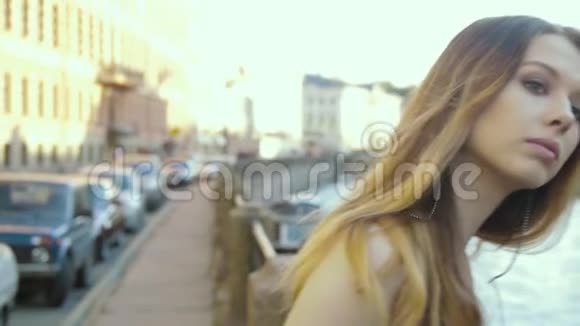 穿着时髦的鸡尾酒连身服的漂亮女孩走在斯洛文尼亚的城市堤岸上视频的预览图