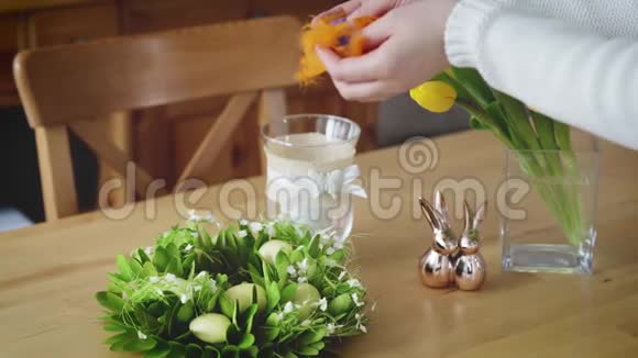 女人把复活节的羽毛铺在桌子上视频的预览图