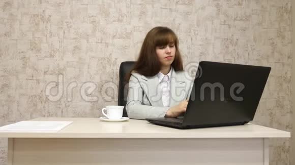 年轻的女孩在电脑办公室工作一位漂亮的女商人在笔记本电脑上写商务信函视频的预览图