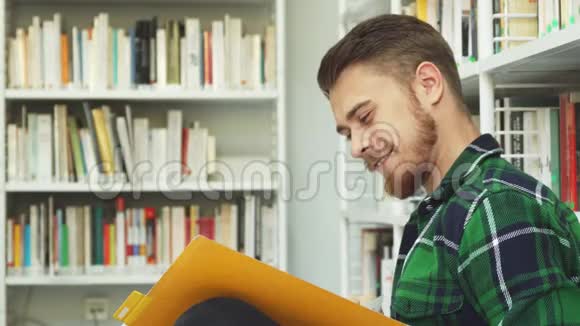 一个笑的家伙坐在图书馆看书视频的预览图