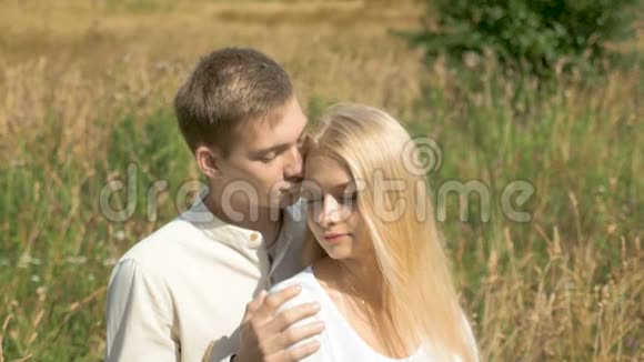 年轻的白人夫妇约会那家伙轻轻地抚摸他的女朋友她闭上了眼睛视频的预览图