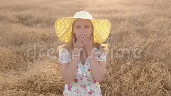 乡下女孩站在田野里送一个吻摄像机拍摄空中视角视频的预览图