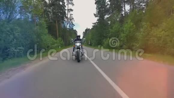 摩托车骑在森林里的空路上视频的预览图
