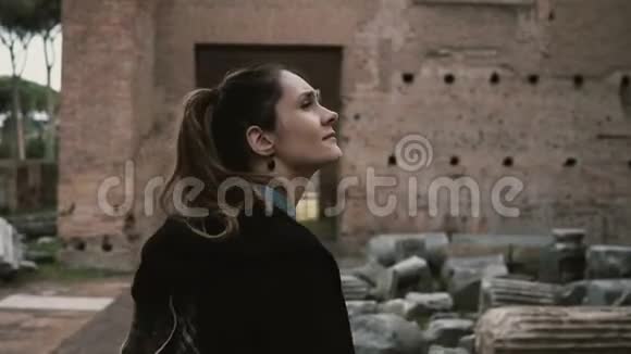 游客在意大利罗马散步了解古代历史女人摸着古色古香的城堡柱子的砖墙视频的预览图
