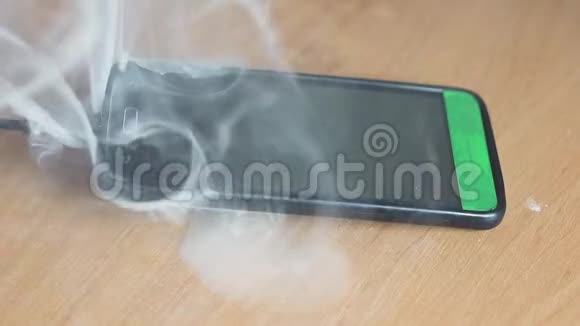 智能手机躺在桌子上吸烟和燃烧很快火就要开始了火灾危险概念视频的预览图