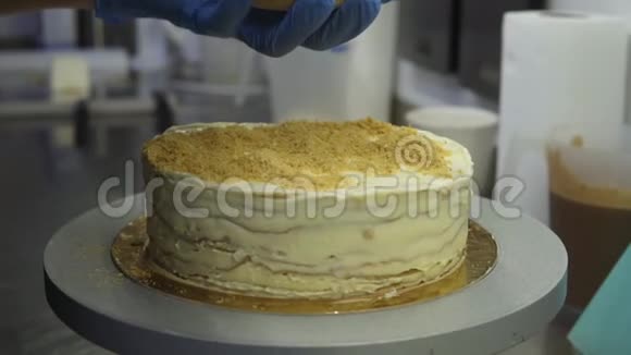 用磨碎的面包覆盖拿破仑蛋糕用糖果刮刀均匀地铺在上面洒满蛋糕视频的预览图