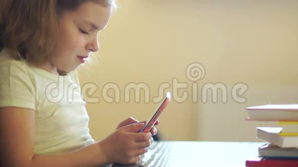 一个女孩在手机上玩游戏网瘾他狡猾地笑着使用手机视频的预览图
