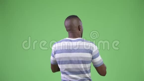 非洲青年男子用电话拍照后景视频的预览图