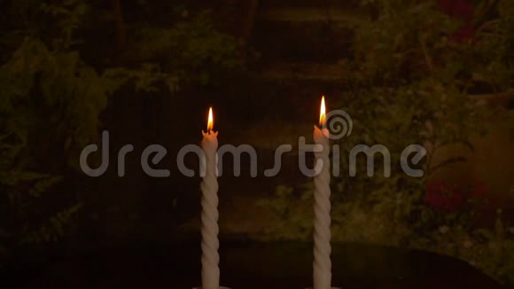 慢动作两支蜡烛按圆圈旋转两支蜡烛的火光冥想或圣诞节概念视频的预览图