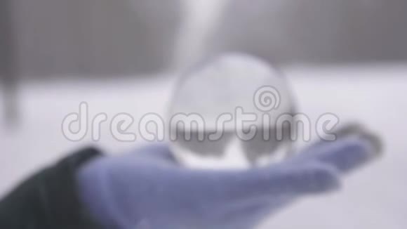 冬天的手掌上的玻璃球在露天视频的预览图