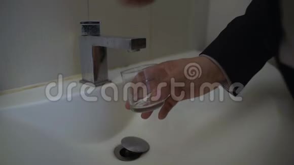 一个试图倒一杯水的人由于债务没有提供公用事业服务视频的预览图