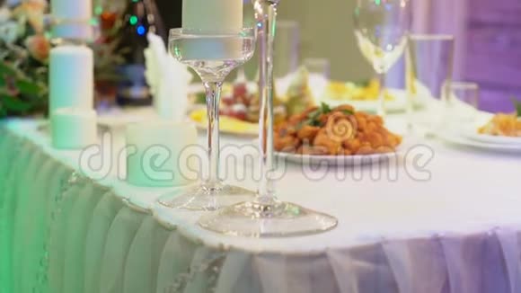 餐厅的宴会桌上有眼镜和蜡烛桌上有装饰蜡蜡烛视频的预览图