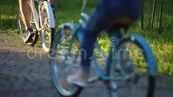 年轻的情侣在公园里骑自行车约会视频的预览图