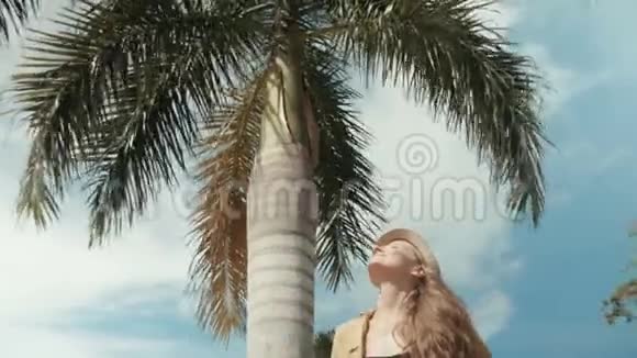 戴草帽的漂亮女人在热带度假胜地享受夏天的肖像视频的预览图