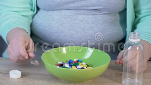 女孩用勺子吃碗里的药片慢动作药品视频的预览图