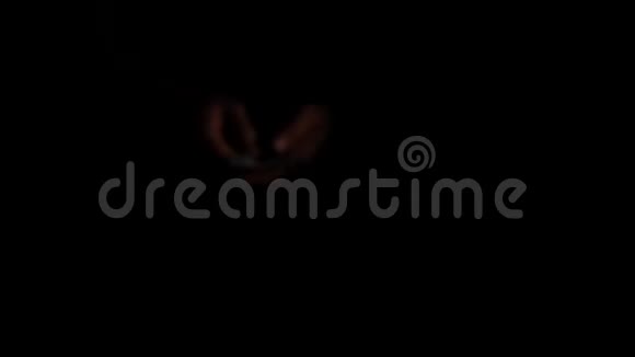 一个人在黑暗中挥舞着一把美元的扇子男人把钱变成扇子快关门4K慢动作视频的预览图