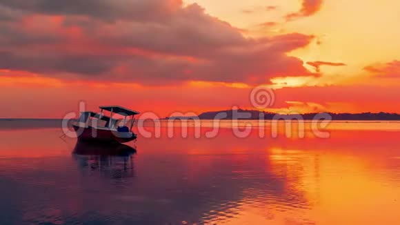 印度尼西亚吉利海上的一艘渔船带着绚丽的红色日落作为猎犬视频的预览图