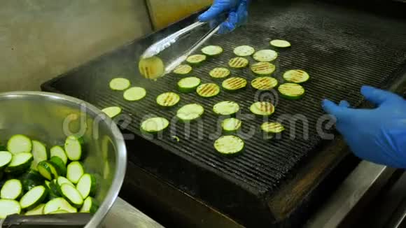 西葫芦炒菜烹饪餐厅在烤架上烹饪蔬菜的过程厨师戴上格栅烤架视频的预览图