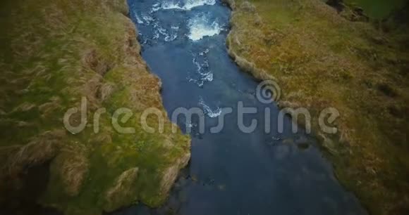 从空中俯瞰山谷中的河流成为冰岛的一个强大的瀑布游客正在寻找视线视频的预览图