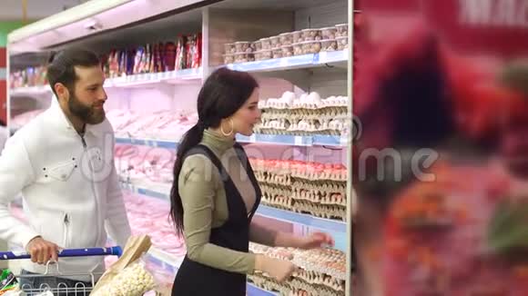 快乐的一对夫妇在超市买鸡蛋慢动作视频的预览图