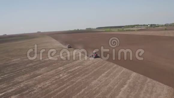 两台拖拉机向相反方向行驶和耕地的鸟瞰图农用拖拉机耕田视频的预览图