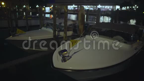 停泊在码头的出租车在运河海浪中摇摆在夜间等待客户视频的预览图