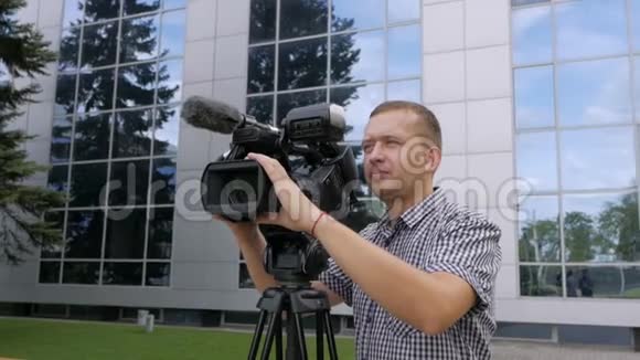 电视操作员用专业的摄像机移除视频摄像机站在三脚架上视频的预览图