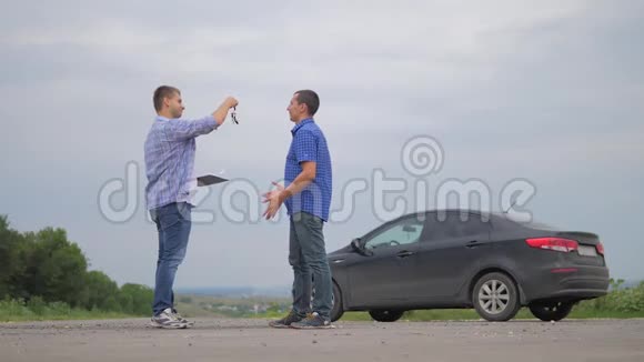 两个人达成协议男人握手交钥匙卖家司机做汽车保险慢动作视频销售视频的预览图