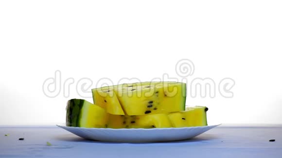 桌子上放着几片黄色的西瓜另一片从上面掉下来视频的预览图