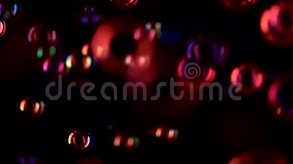 红色的肥皂泡飞得很近慢动作黑色背景视频的预览图