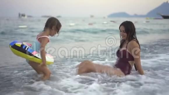 海中有个小孩的年轻女子视频的预览图