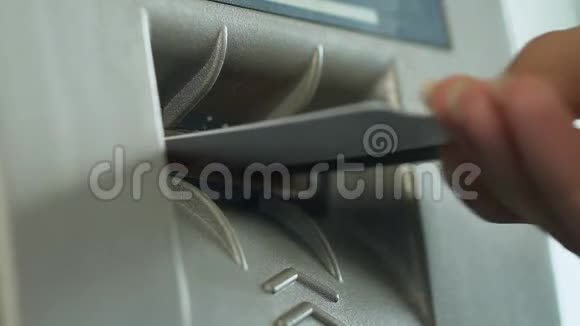 女性将信用卡插入ATM机以检查她的余额轻松的银行业务特写视频的预览图