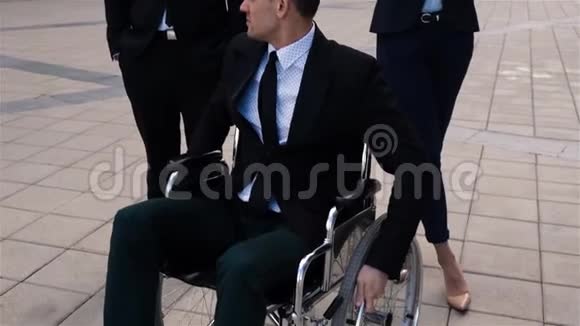 与同事坐在轮椅上的残疾男子的史诗级镜头视频的预览图
