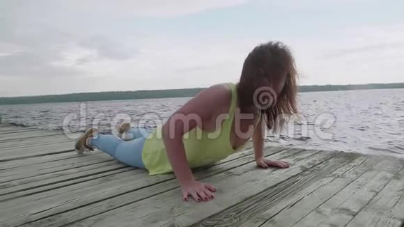 年轻女子躺在木墩上与摄像男子交谈视频的预览图