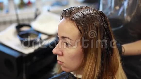 理发师把染发剂涂在相框里的头发上视频的预览图