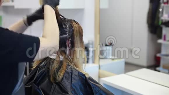 理发师把染发剂涂在头发上视频的预览图
