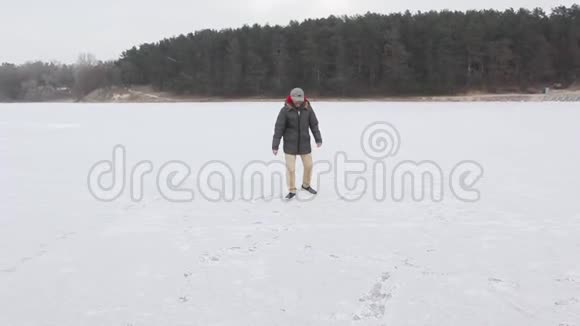 年轻的黑人在森林附近的冰上滑过视频的预览图