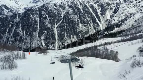 雪覆盖的山脉和滑雪电梯的美丽鸟瞰图4k视频的预览图