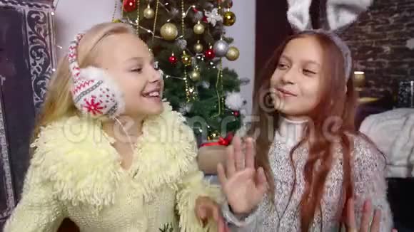 两个女孩耳机听音乐圣诞节视频的预览图