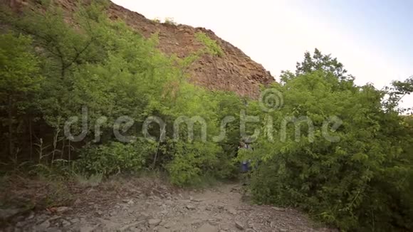 两名游客沿着山间小径散步视频的预览图