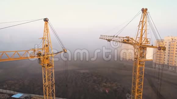 施工现场在雾中用鸟眼用塔吊顶着夕阳视频的预览图