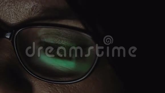 一个戴眼镜的女人眼睛的特写一个女人看着平板电脑视频的预览图
