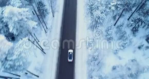 汽车在冬天的路上行驶冬天的道路树木和灌木丛覆盖着雪视频的预览图