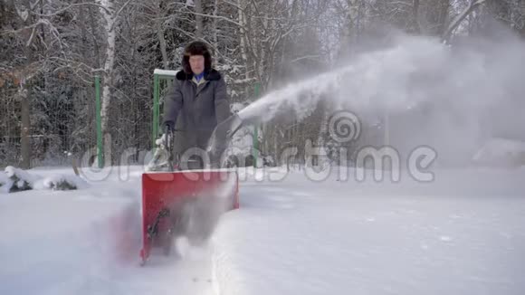 男子清雪除雪机背景冬季森林视频的预览图