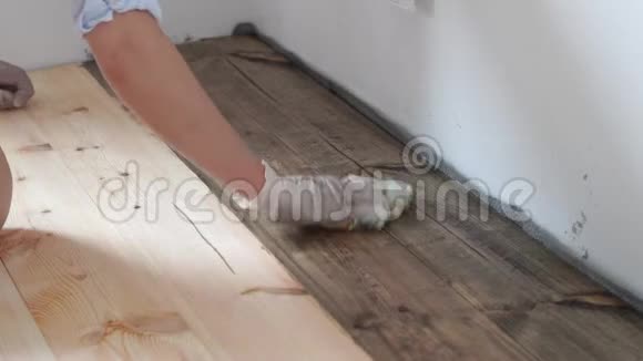 修理和装饰主人在木地板上涂上一层环保涂层天然油蜡深色视频的预览图