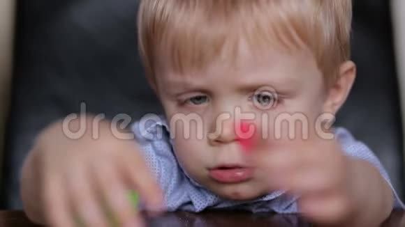 悲伤的小男孩玩五颜六色的塑料视频的预览图